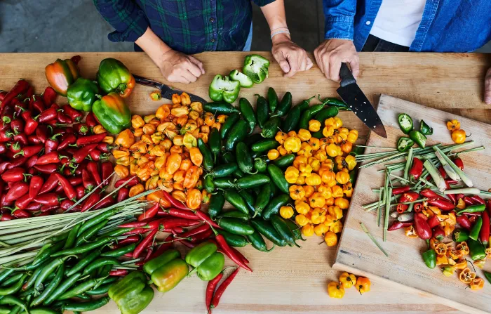 Chilli peppers and ingredients on wooden background