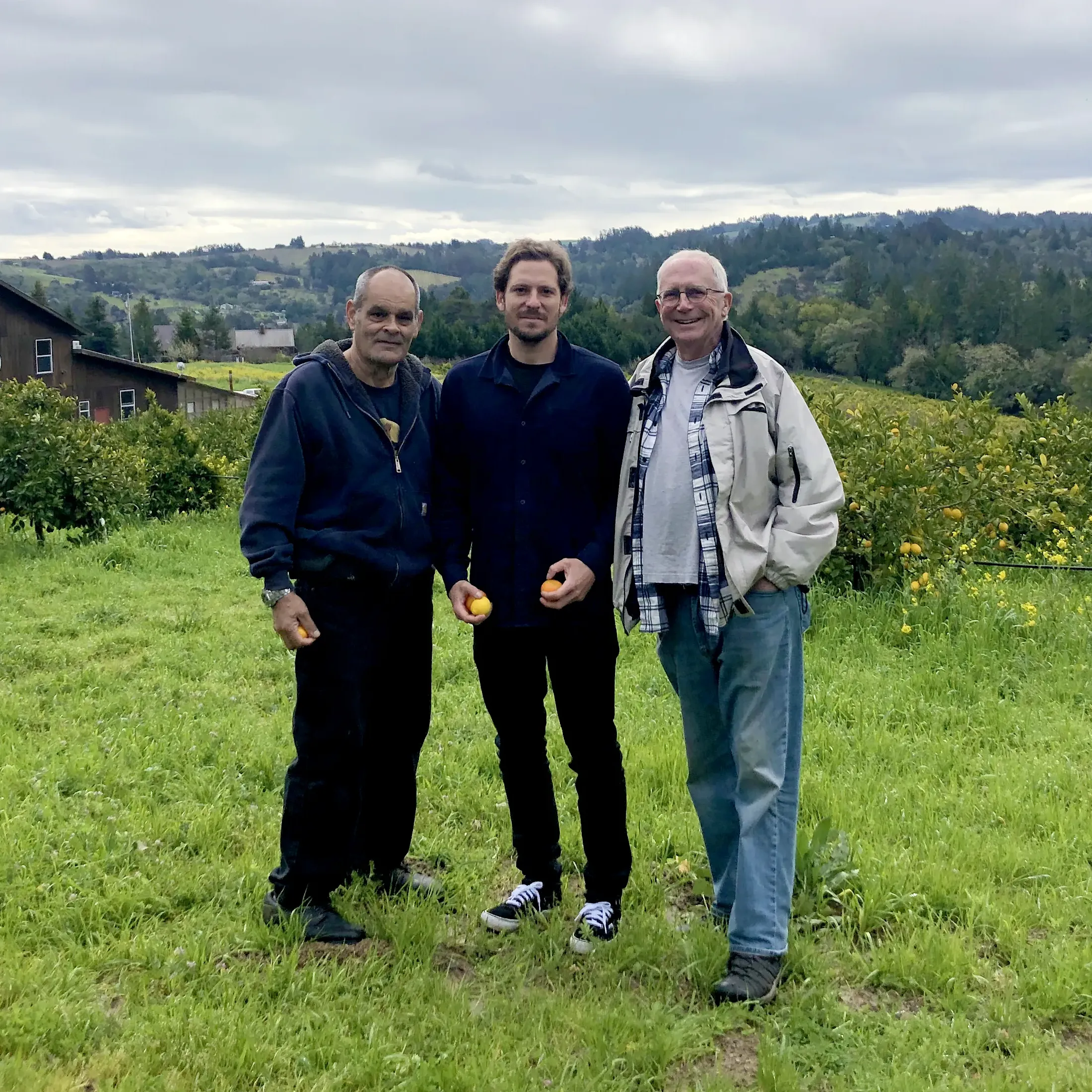 Photo of farming partners and Brandon Hanson standing in the countryside