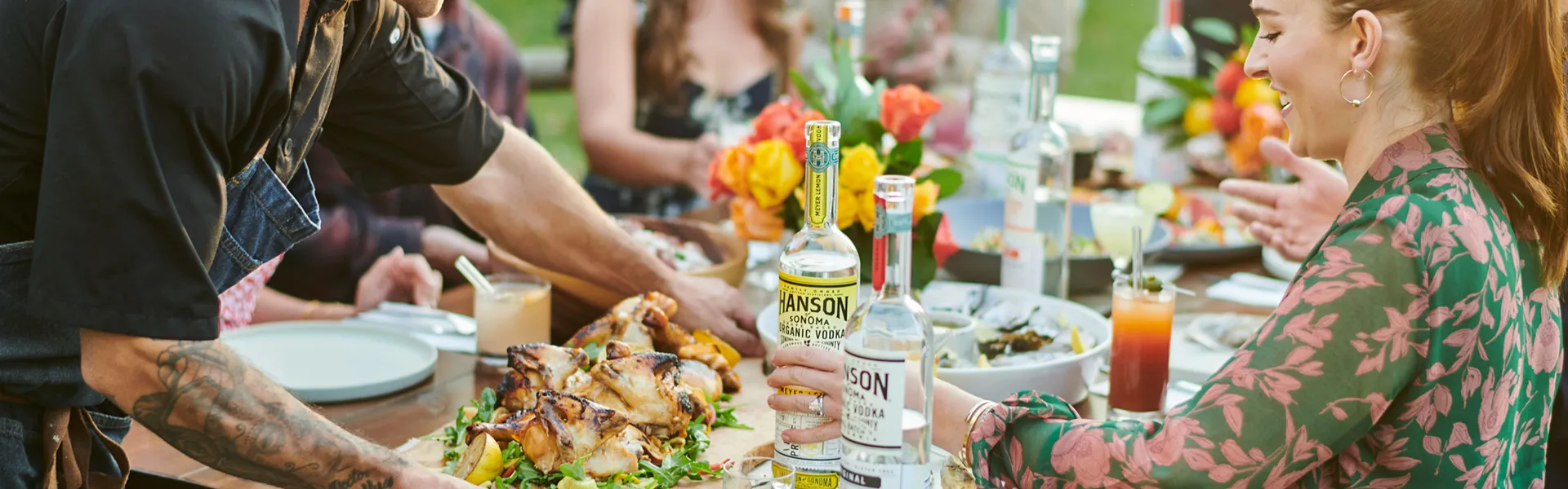 Chef serving platter of food for guests drinking hanson vodka