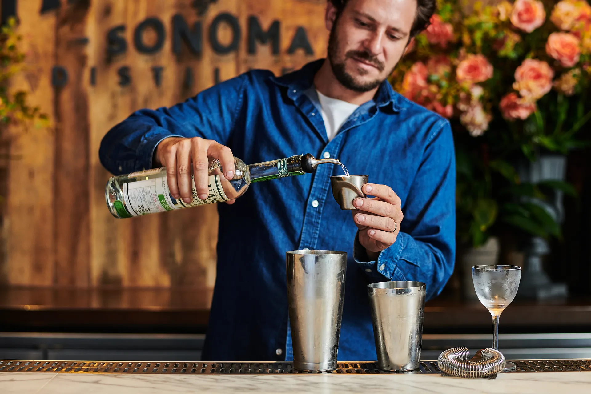 Brandon Hanson pouring some Hanson Vodka into a cocktail mixer